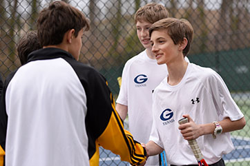 Students shaking hands during a game. Link to Gifts of Life Insurance